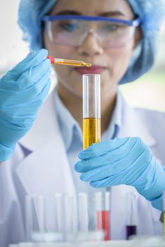 Asian young girl student scientist researching  and learning in a laboratory.