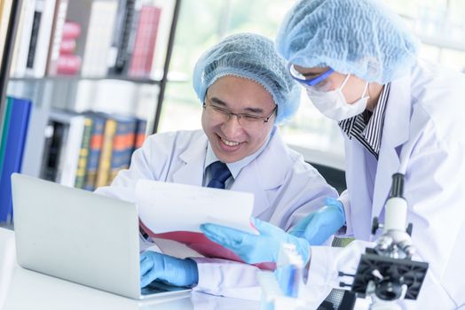 Asian senior scientist male researching and learning in a laboratory.