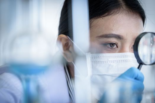 Asian young girl student scientist researching  and learning in a laboratory.