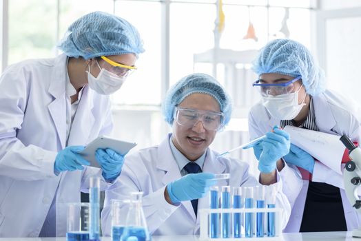 Asian scientist team has researching in laboratory.