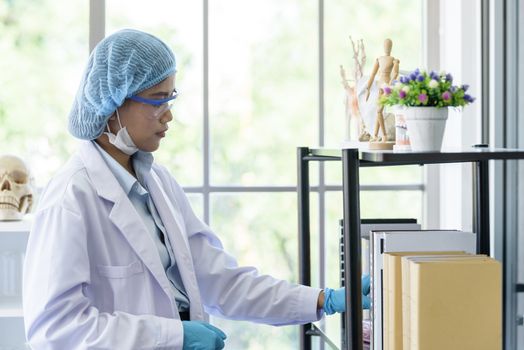 Asian young girl student scientist researching  and learning in a laboratory.