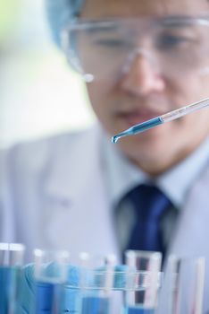 Asian senior scientist male researching and learning in a laboratory.