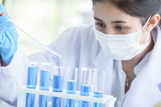 Asian young girl student scientist researching  and learning in a laboratory.