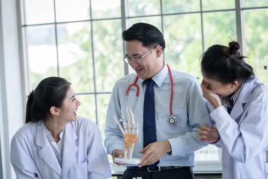 Asian teacher has teaching to student about science and anatomical in laboratory