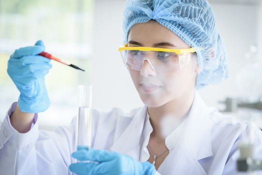 Asian young girl student scientist researching  and learning in a laboratory.