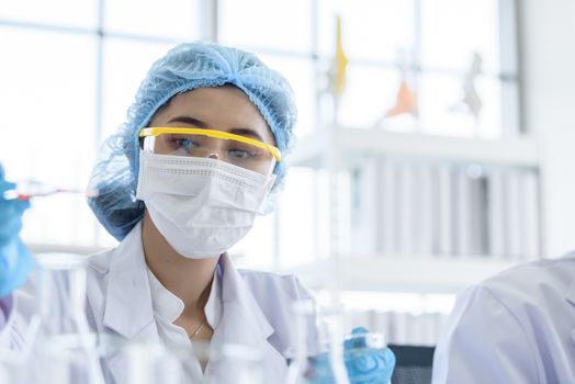 Asian young girl student scientist researching  and learning in a laboratory.