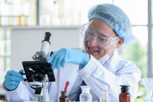 Asian man scientist researching  and learning in a laboratory.