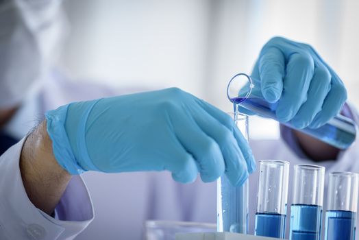 Asian man scientist researching  and learning in a laboratory.