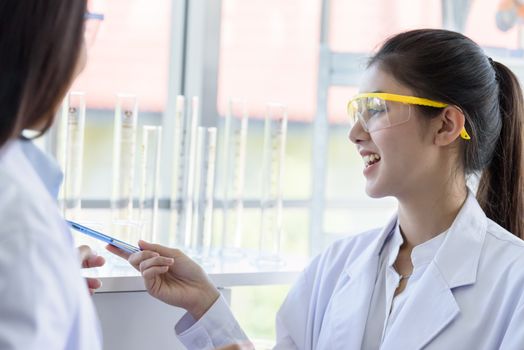 Asian young female working and research scientist together.