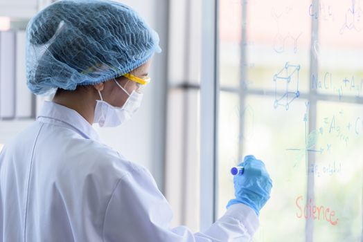 Asian young girl student scientist researching  and learning in a laboratory.