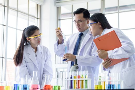 Asian senior laboratory scientist man working at lab with asian young student scientist backgroud.