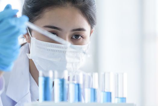 Asian young girl student scientist researching  and learning in a laboratory.