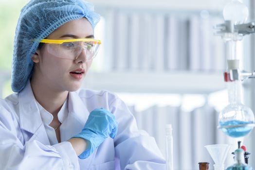 Asian young girl student scientist researching  and learning in a laboratory.