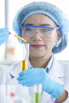 Asian young girl student scientist researching  and learning in a laboratory.