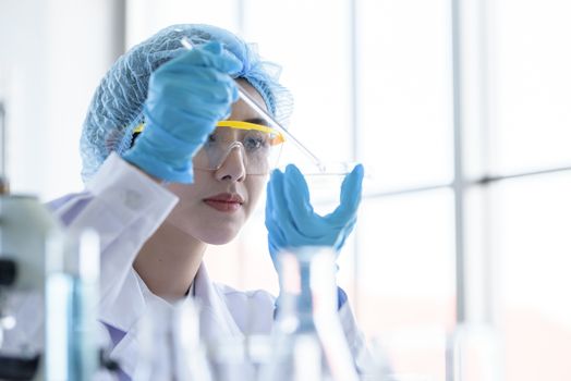 Asian young girl student scientist researching  and learning in a laboratory.