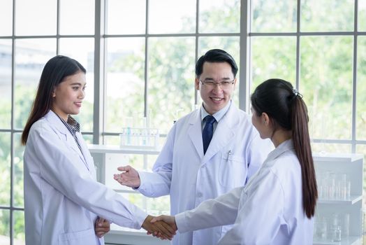 Asian scientist team have meeting in laboratory.