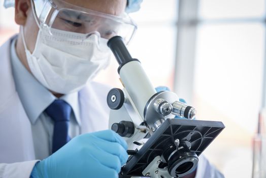 Asian man scientist researching  and learning in a laboratory.