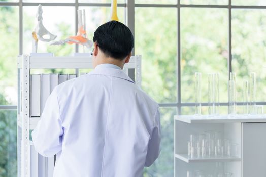 Asian senior scientist researching and learning in a laboratory.