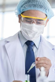 Asian senior scientist have teaching young student scientist in a laboratory.