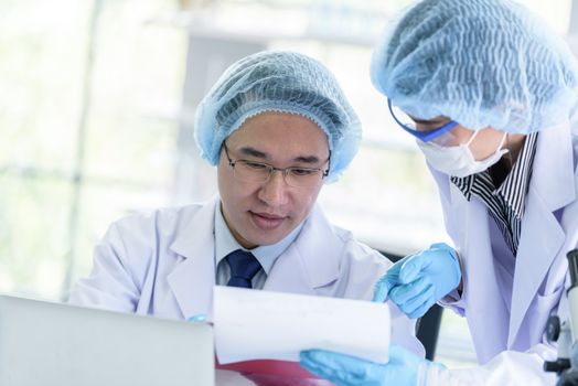 Asian senior scientist male researching and learning in a laboratory.