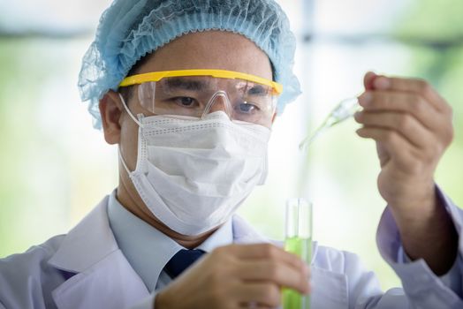 Asian senior scientist have teaching young student scientist in a laboratory.