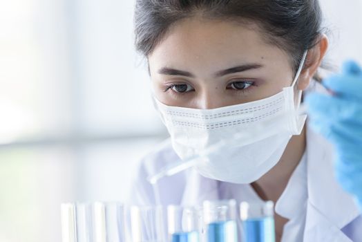 Asian young girl student scientist researching  and learning in a laboratory.