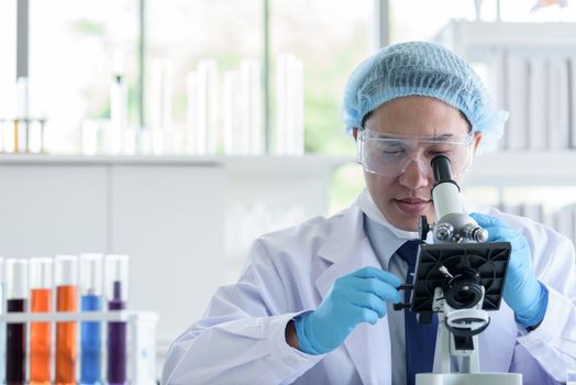 Asian man scientist researching  and learning in a laboratory.