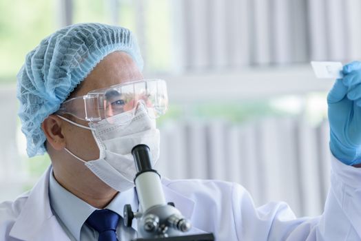 Asian man scientist researching  and learning in a laboratory.