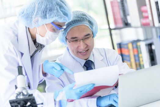 Asian senior scientist male researching and learning in a laboratory.