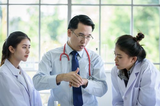 Asian teacher has teaching to student about science and anatomical in laboratory