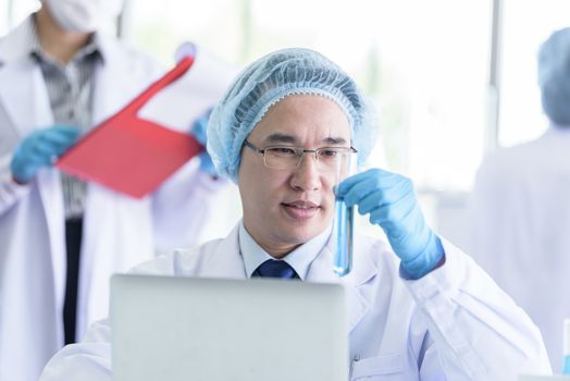 Asian senior scientist male researching and learning in a laboratory.