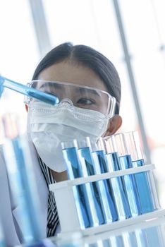 Asian young girl student scientist researching  and learning in a laboratory.