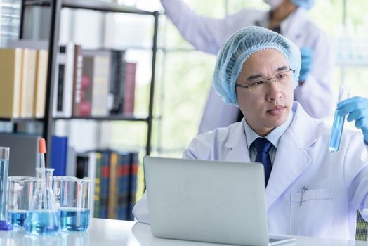 Asian senior scientist male researching and learning in a laboratory.