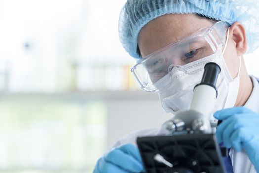 Asian man scientist researching  and learning in a laboratory.