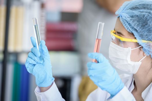 Asian young girl student scientist researching  and learning in a laboratory.