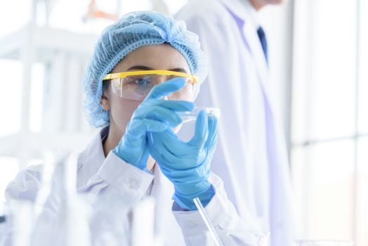 Asian young girl student scientist researching  and learning in a laboratory.