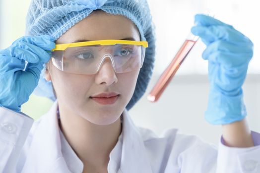 Asian young girl student scientist researching  and learning in a laboratory.