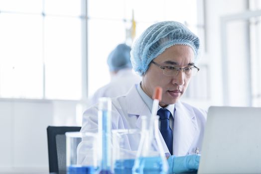 Asian senior scientist male researching and learning in a laboratory.