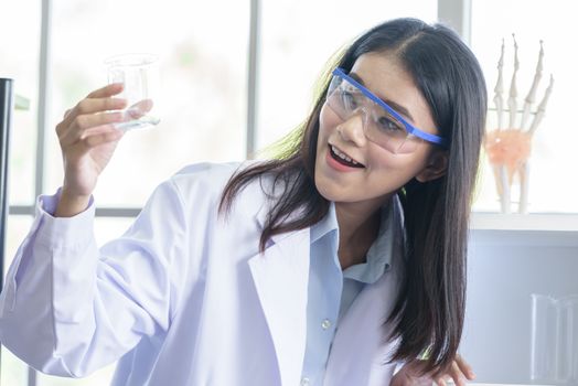 Asian young girl student scientist researching  and learning in a laboratory.