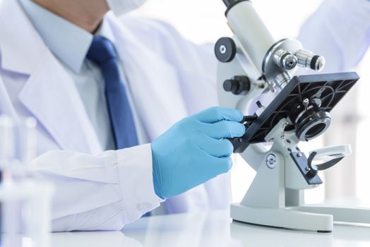 Asian man scientist researching  and learning in a laboratory.