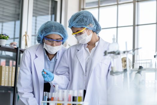 Asian young female working and research scientist together.