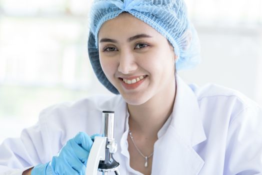 Asian young girl student scientist researching  and learning in a laboratory.