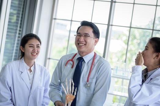 Asian teacher has teaching to student about science and anatomical in laboratory