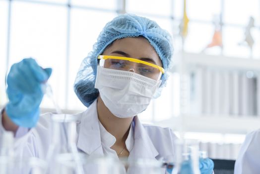 Asian young girl student scientist researching  and learning in a laboratory.