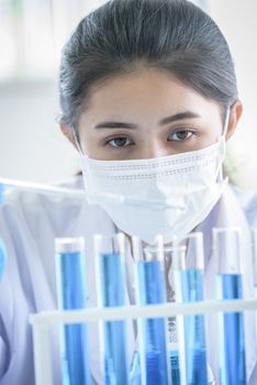 Asian young girl student scientist researching  and learning in a laboratory.