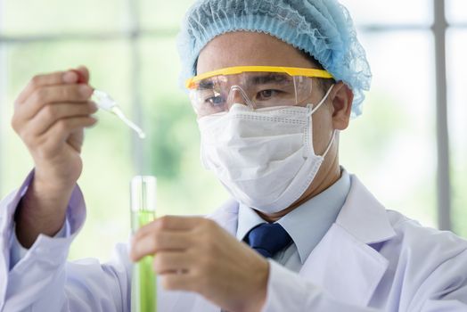 Asian senior scientist have teaching young student scientist in a laboratory.