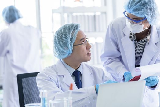 Asian senior scientist male researching and learning in a laboratory.