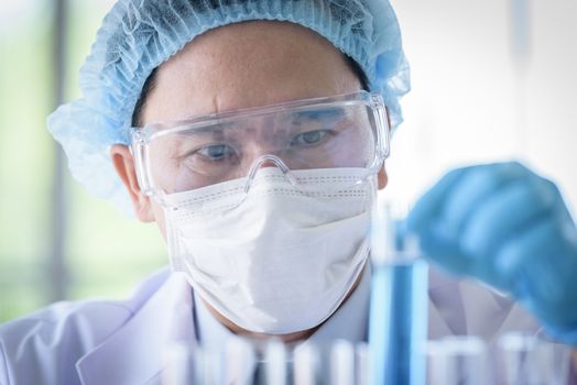 Asian man scientist researching  and learning in a laboratory.