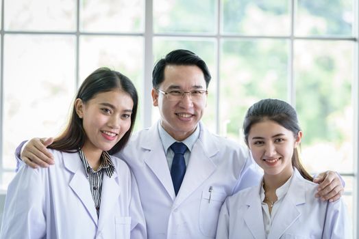 Asian scientist and researching team has in laboratory.