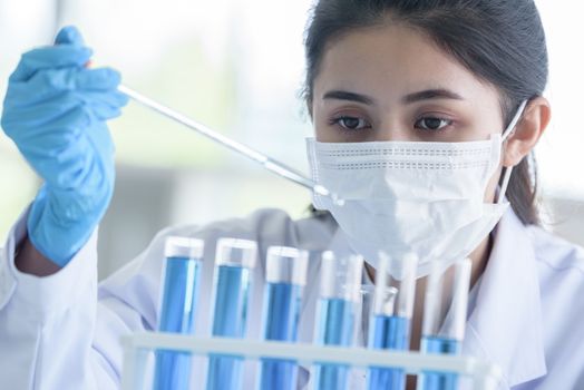 Asian young girl student scientist researching  and learning in a laboratory.